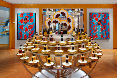 The table display at Maison Guerlain in Paris with pieces of art displayed on the walls for "The Flowers of Evil" exhibition. Image: ©ARR, Guerlain